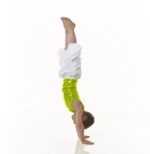 A young Cavod Performing Arts Kindergym student doing a handstand.