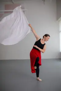 A dancer from Cavod's adult worship dance class holding a white flag