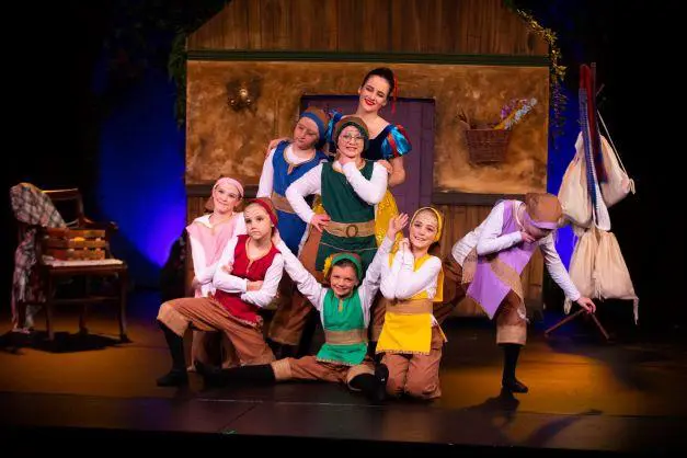 A troupe of young Cavod dancers portraying the seven dwarves, with sSow White in the back. 