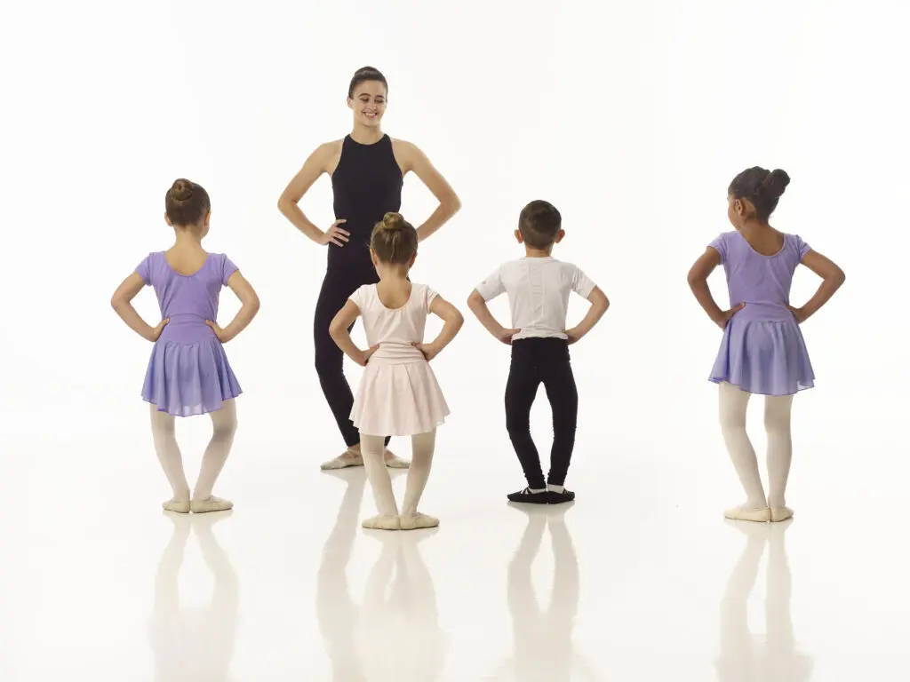 A dance instructor at Cavod Academy teaching young dancers basic choreographed movesets.