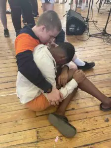 A boy from Cavod Academy consoling another boy while on a missions trip in Capetown, South Africa.