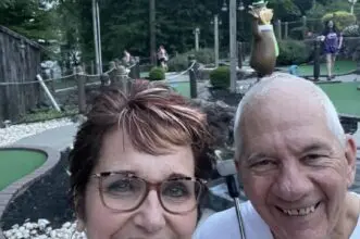Cavod's Founder Connie Dienner playing mini golf with her husband.