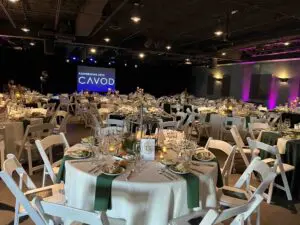 A convention center hall decorated and set up for Cavod Academy's fundraiser banquet. 