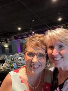 Cavod Academy's Connie Dienner posing for a picture with her friend while attending Cavod Academy's fundraiser banquet.