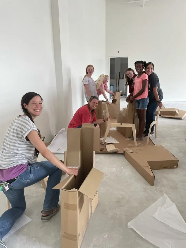 A group of women volunteers helping set up chairs at Cavod Performing Arts' Manheim location.