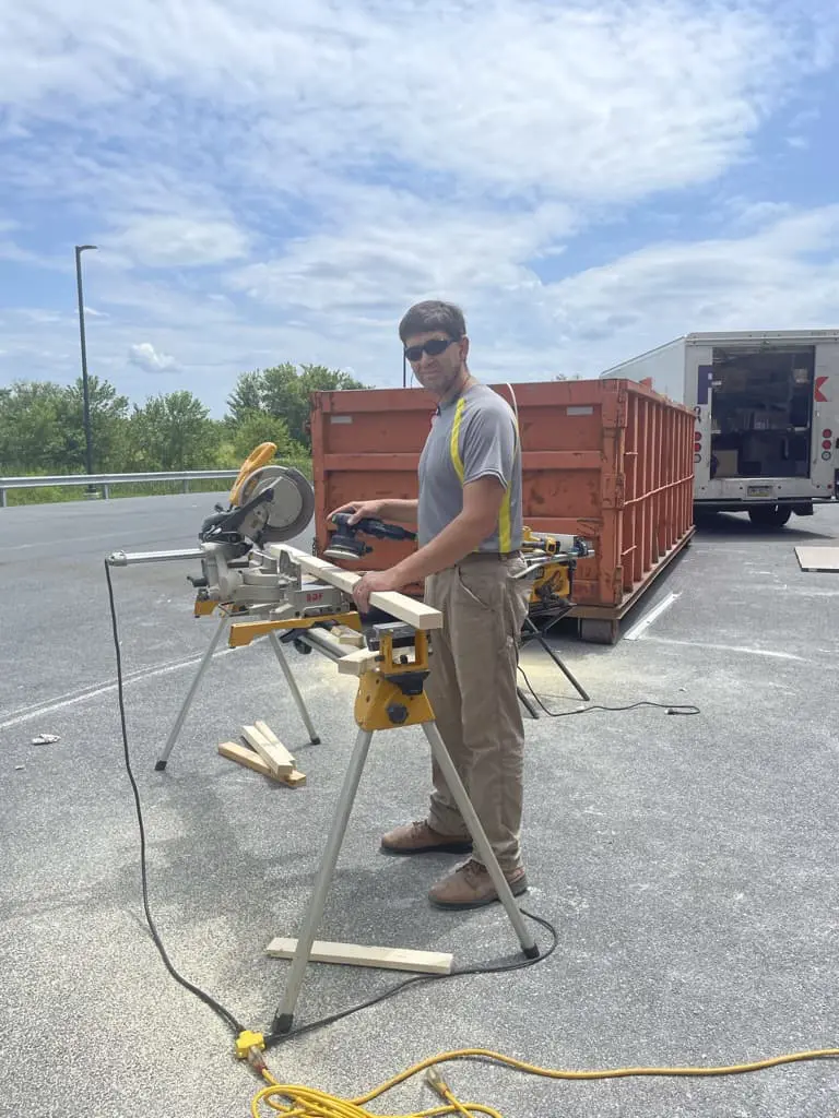 A man helping cut wooden beams for Cavod's new Manheim, PA location | Cavod Performing Arts