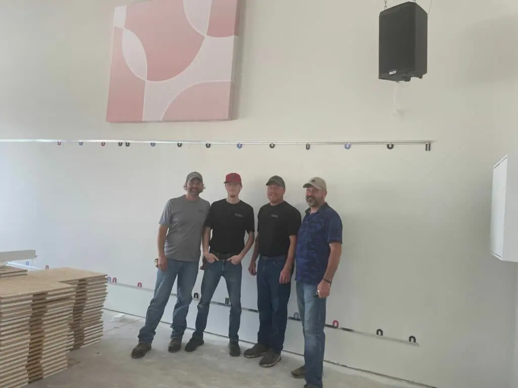 Four men from Esh's Electric posing for a picture in between installing sound systems at Cavod Performing Arts in Manheim, PA.