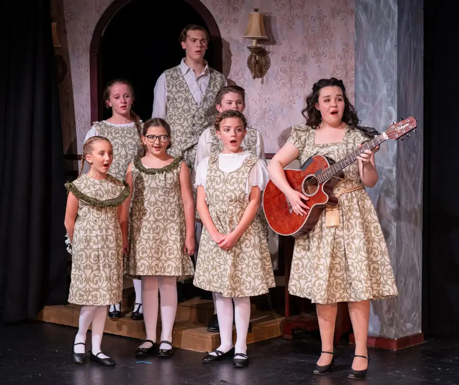 Actors from Cavod singing while portraying the Von Trapp family in their 2023 production of The Sound Of Music.