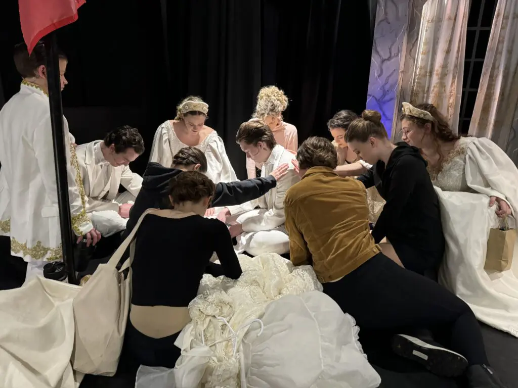 Cast members from Cavod Theatre's 2024 production of Anastasia praying before the show.