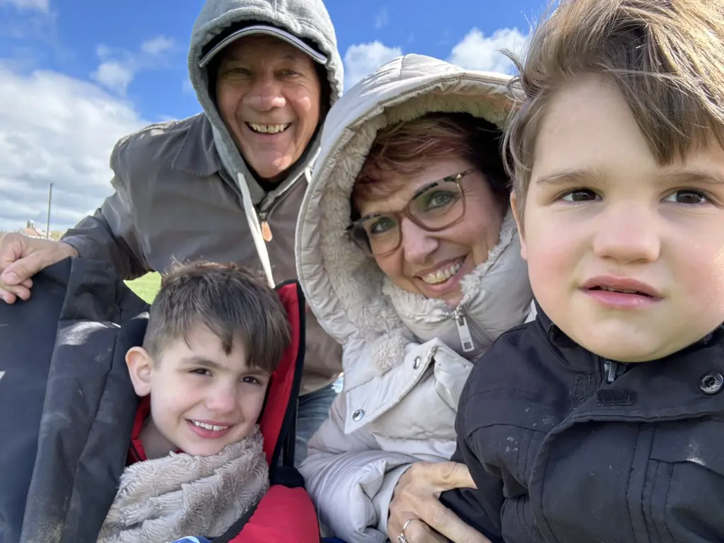 Connie Dienner and her husband taking a selfie with two of her grandchildren