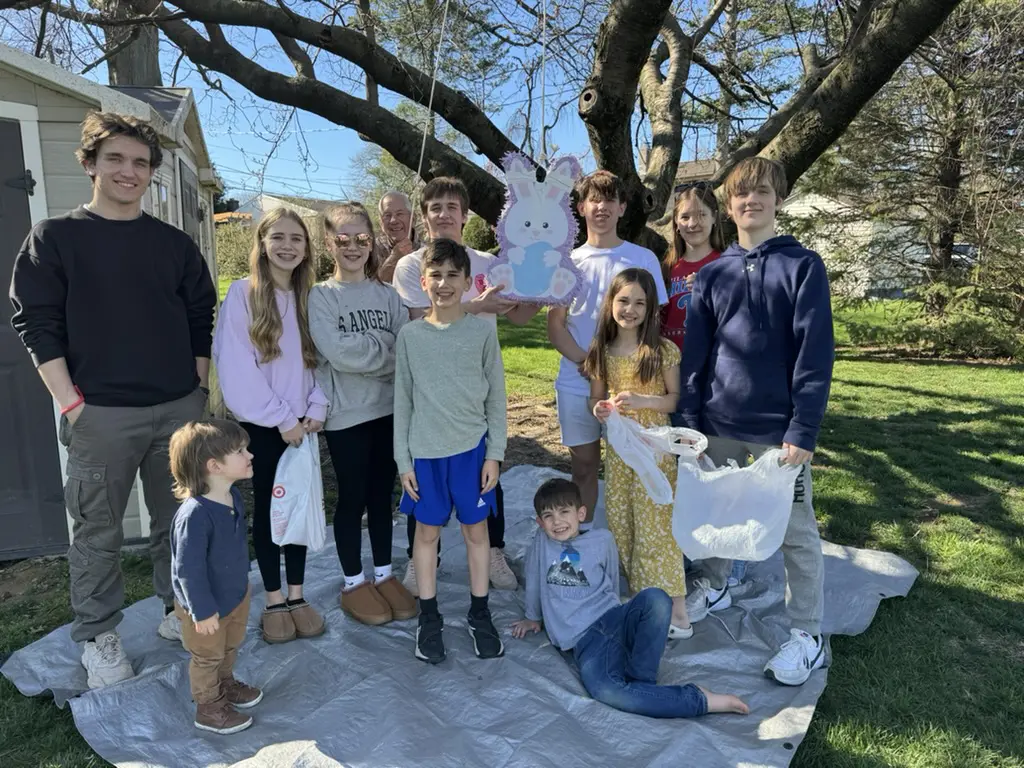 The Dienner family posing next to a pinata while celebrating Easter