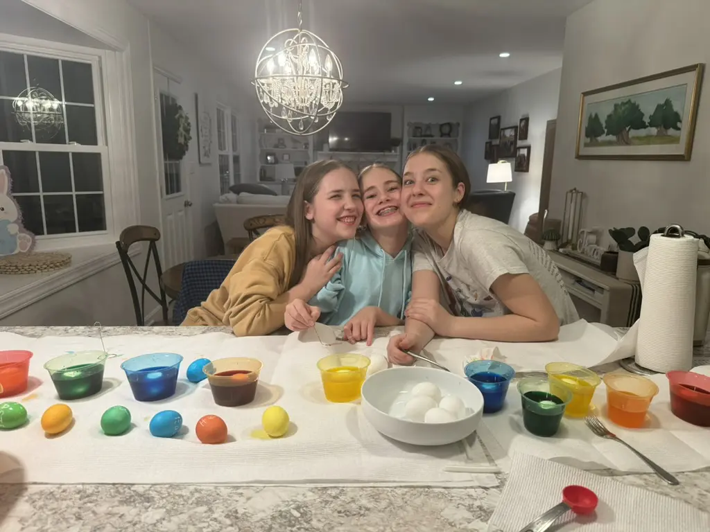 Children painting eggs for Easter