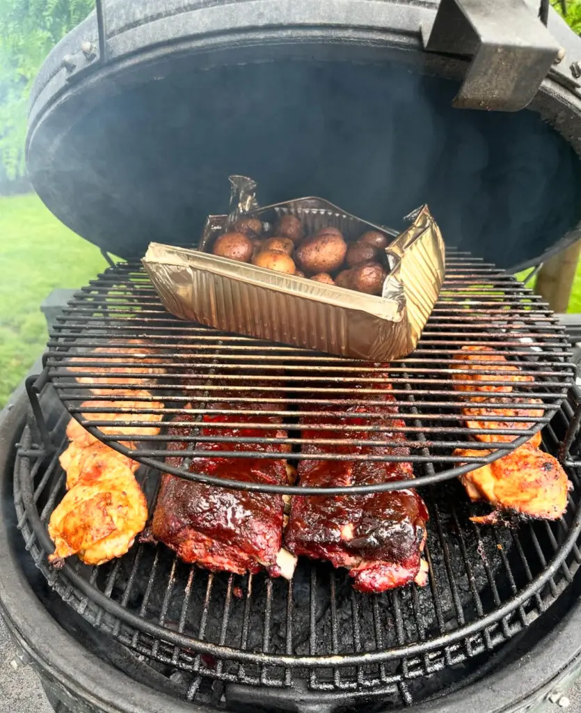 Grilled ribs and potatoes on a grill