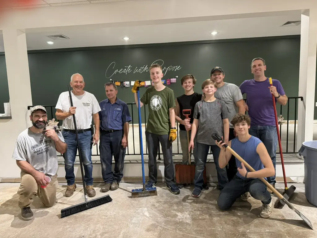 Cavod friends, coworkers, and family remodeling a basement together