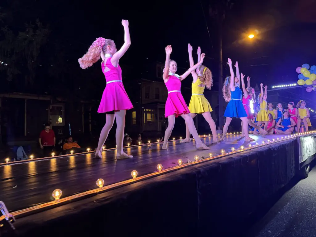 Group of girls dancing on the 20th-anniversary float in celebration,