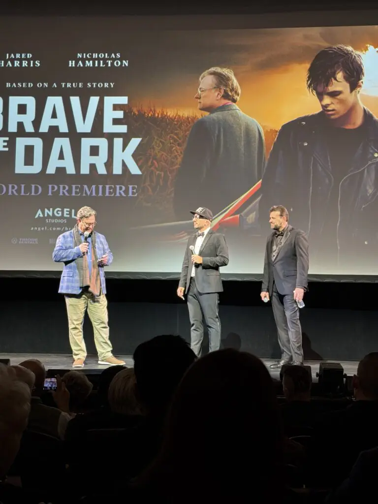 Derek Stoltzfus, producer of "Brave the Dark," standing on stage at the Fulton Theatre, celebrating the film’s premiere.