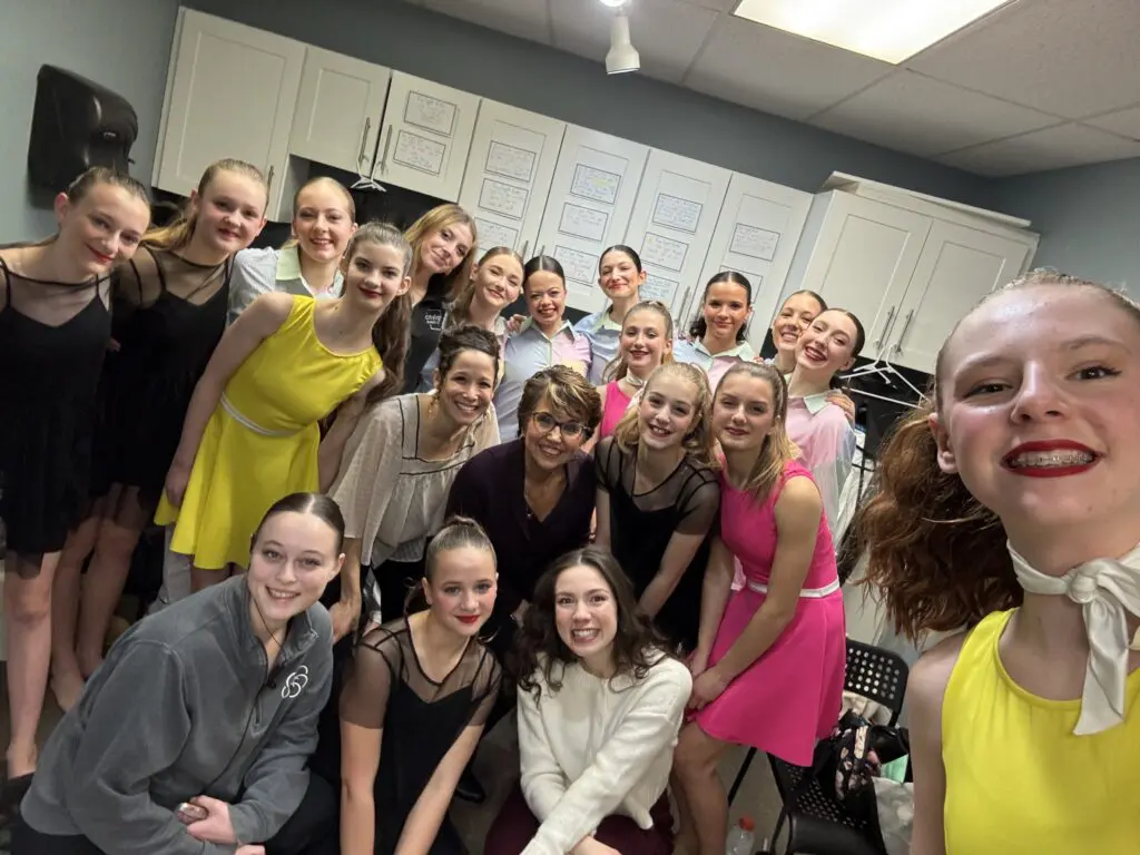 Connie standing with Cavod Performing Arts students, sharing encouragement and celebrating their journey in the arts.