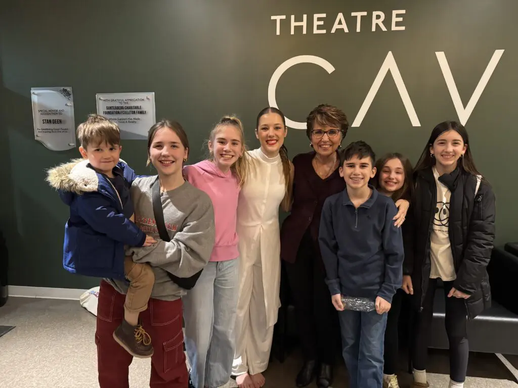 Connie with her grandchildren, all smiling together at Cavod Performing Arts, celebrating faith, family, and community.