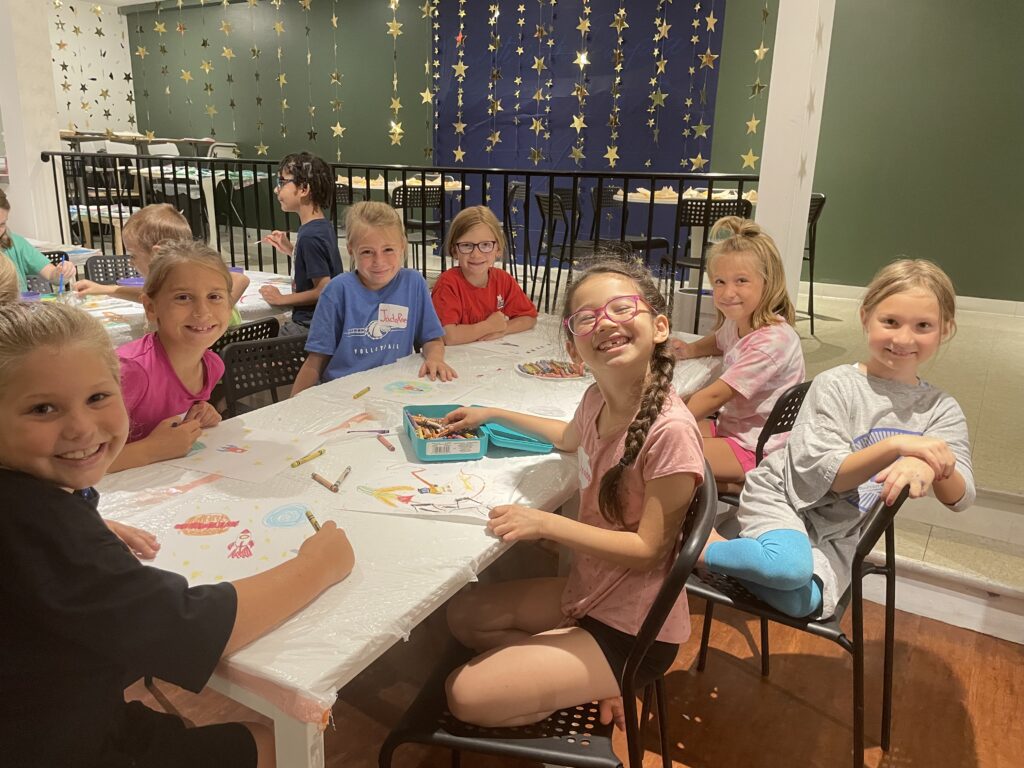 “Stars In Space” Camp kids sitting at a table