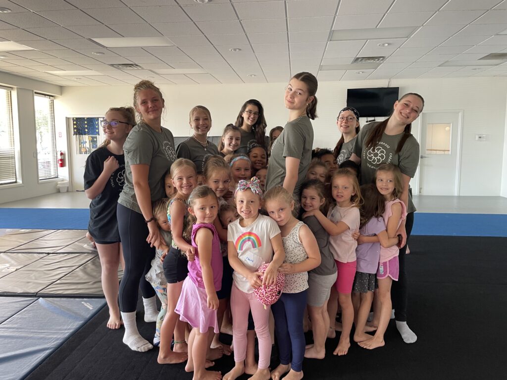 “Stars In Space” Camp kids and counselors posing for a photo in the dance studio