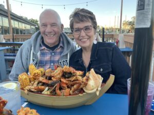 Cavod Academy's Connie Dienner enjoying a bowl of seafood with friends and family.
