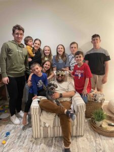 A group of family members smiling while posing for a picture.